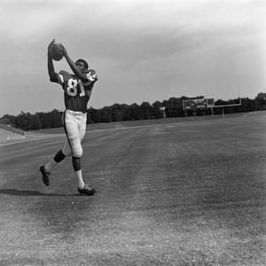 Primary view of [NTSU football player catching a ball]