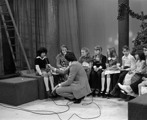 Primary view of [Photograph of Bill Kelley interviewing a young girl at a KXAS Christmas Children's Hour party]