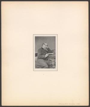 Primary view of [Charles Dickens reading at his desk]
