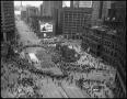 Photograph: [Aerial image of a parade in downtown, 1]