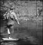 Photograph: [Boy poking at the water with a stick, 3]