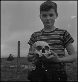 Primary view of [Raymond Clark holding a human skull, 3]