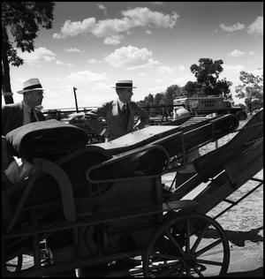 Primary view of [Henry Ford standing next to a thresher]